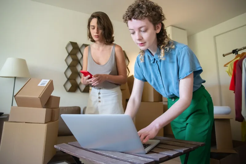 Warehouse staff scanning inventory with handheld barcode scanner and tablet