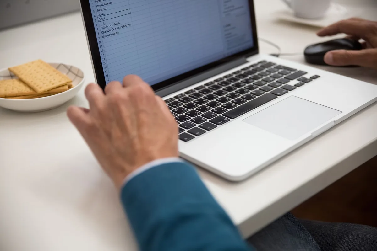 Ecommerce seller working on a laptop to manage inventory using an Excel spreadsheet for Philippine marketplace operations