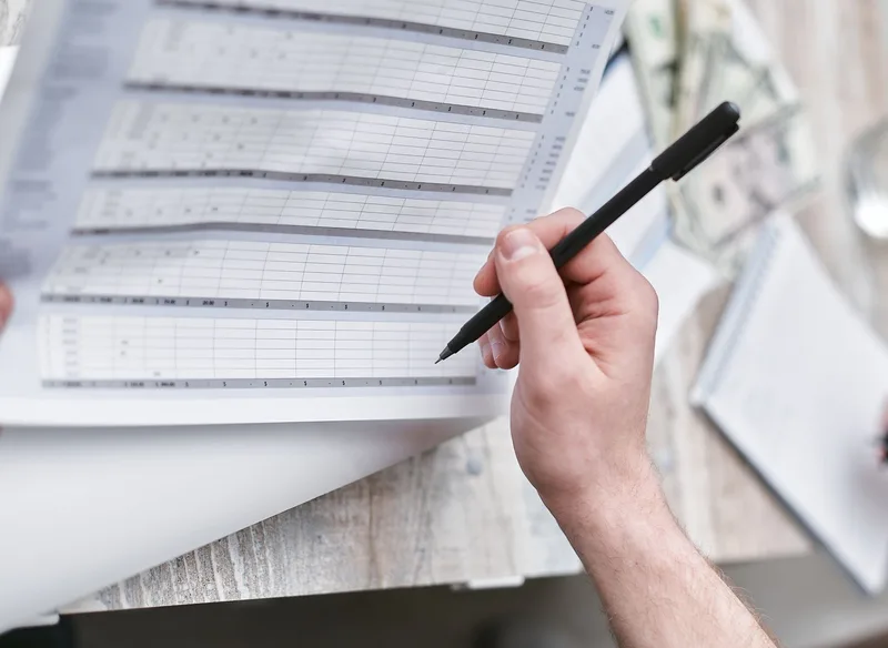 Businesswoman reviewing a financial spreadsheet with charts, representing the structured approach to inventory tracking in Excel for Philippine ecommerce