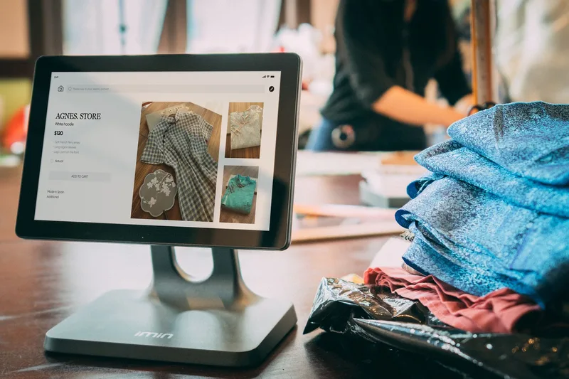 Two people reviewing an online store on a laptop — representing the multi-channel management challenge that inventory tracking programs address for Philippine sellers