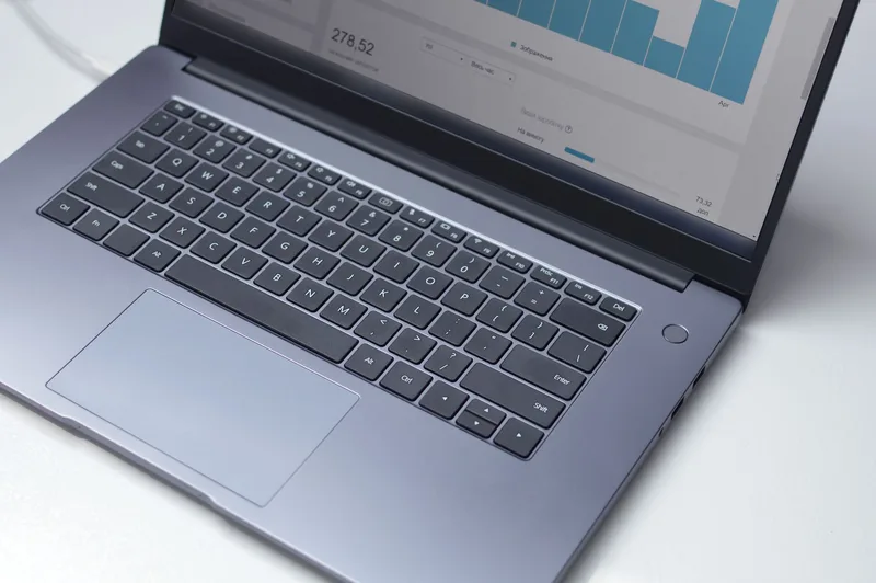 Laptop displaying an analytics dashboard on a desk, representing the reorder-point view a procurement platform surfaces before generating a draft order