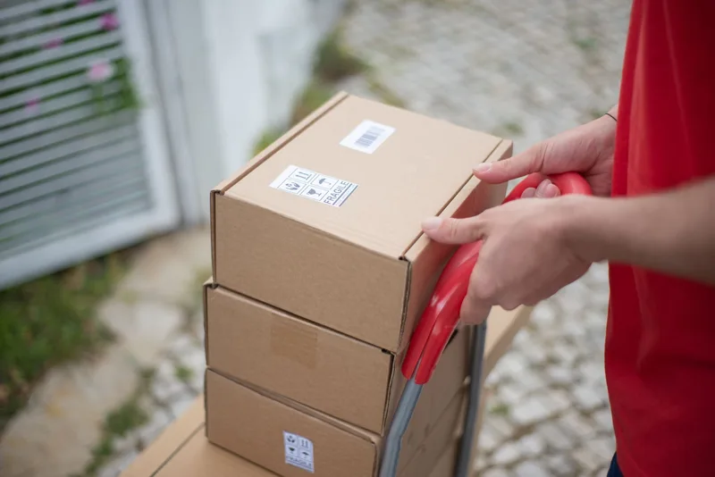 Cardboard shipping boxes stacked and ready for courier pickup