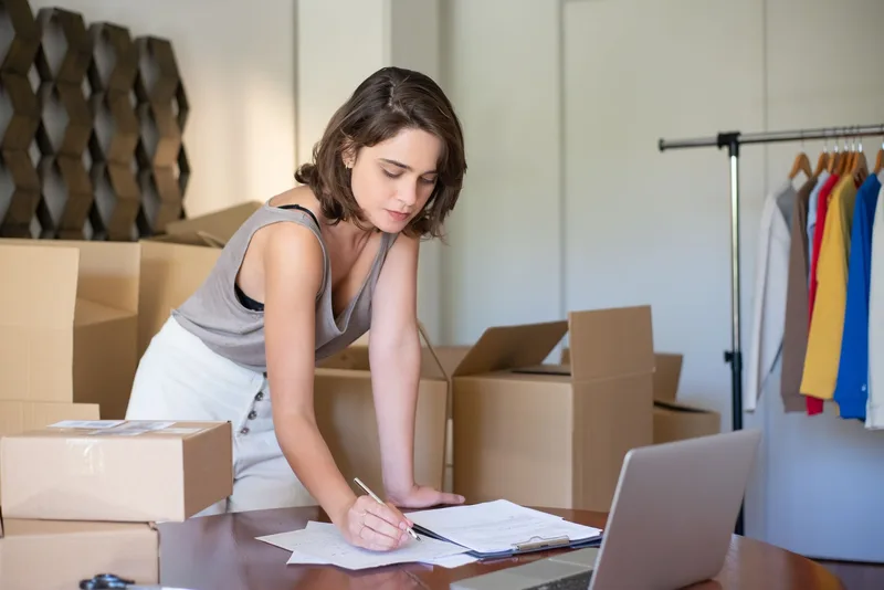 Philippine ecommerce seller reviewing warehouse stock levels on a laptop before choosing a WMS system