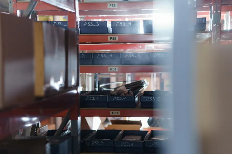 Warehouse shelving unit with numbered bins showing organised storage locations used in a WMS warehouse management system